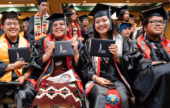 Several students at graduation held their diplomas.