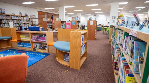 Library shelves full of books at San Simon School.