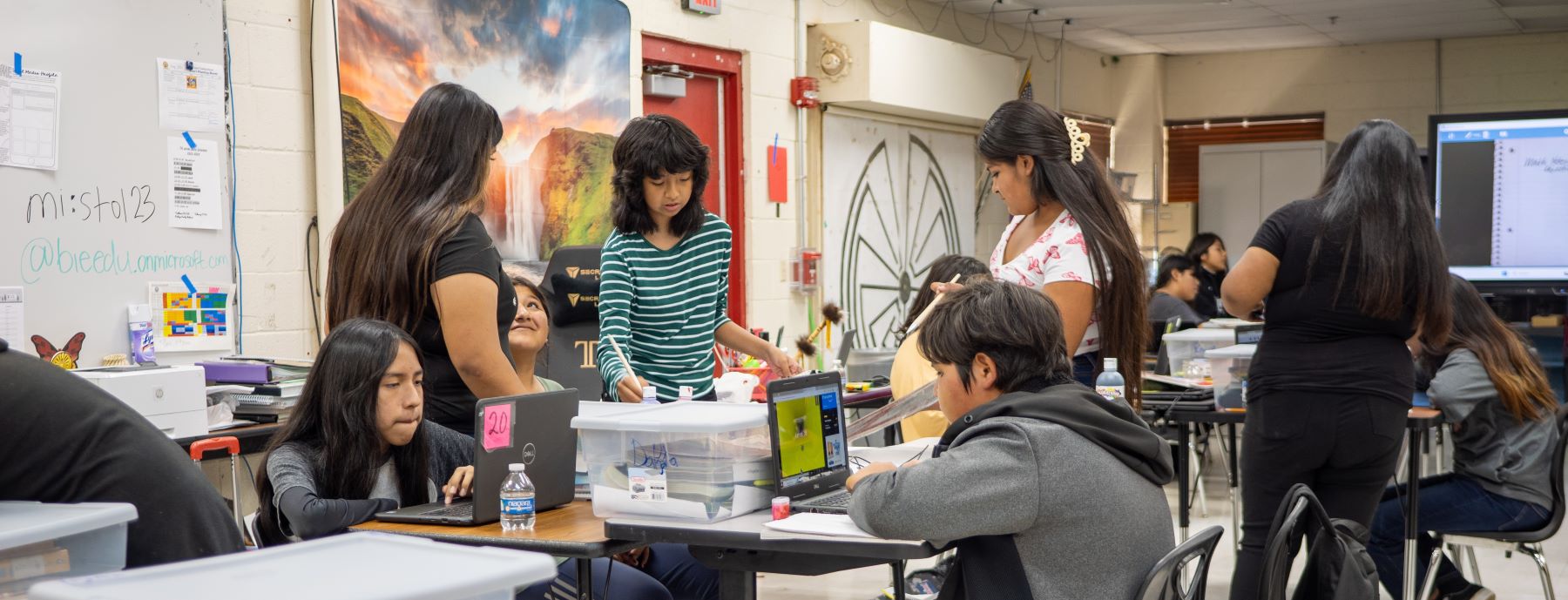 Busy classroom with students working on various projects.