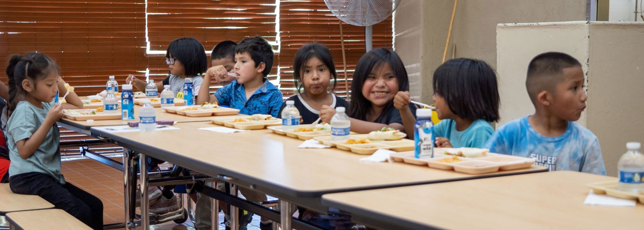 Young students eating lunch in the school's cafeteria. 